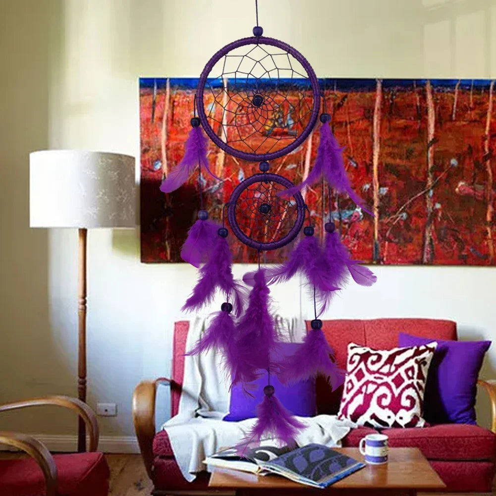 Purple dreamcatcher hanging in a living room with a red couch and colorful painting.