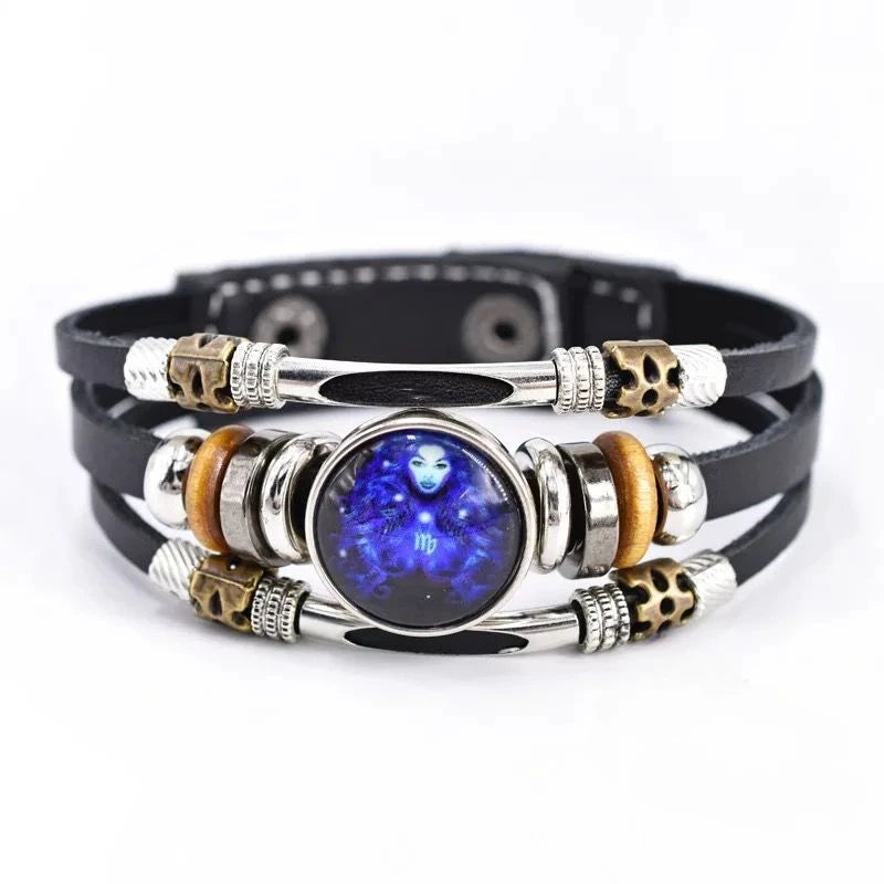 Multistrand leather bracelet with blue central stone and metallic accents on a white background