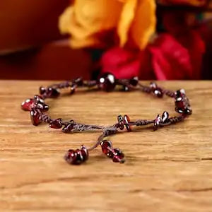 Bracelet with red beads on a wooden surface