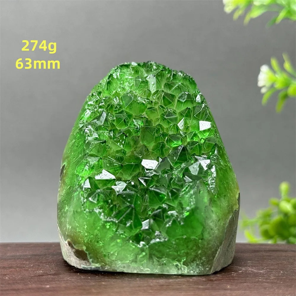 Green crystal rock on a wooden surface with a gray background