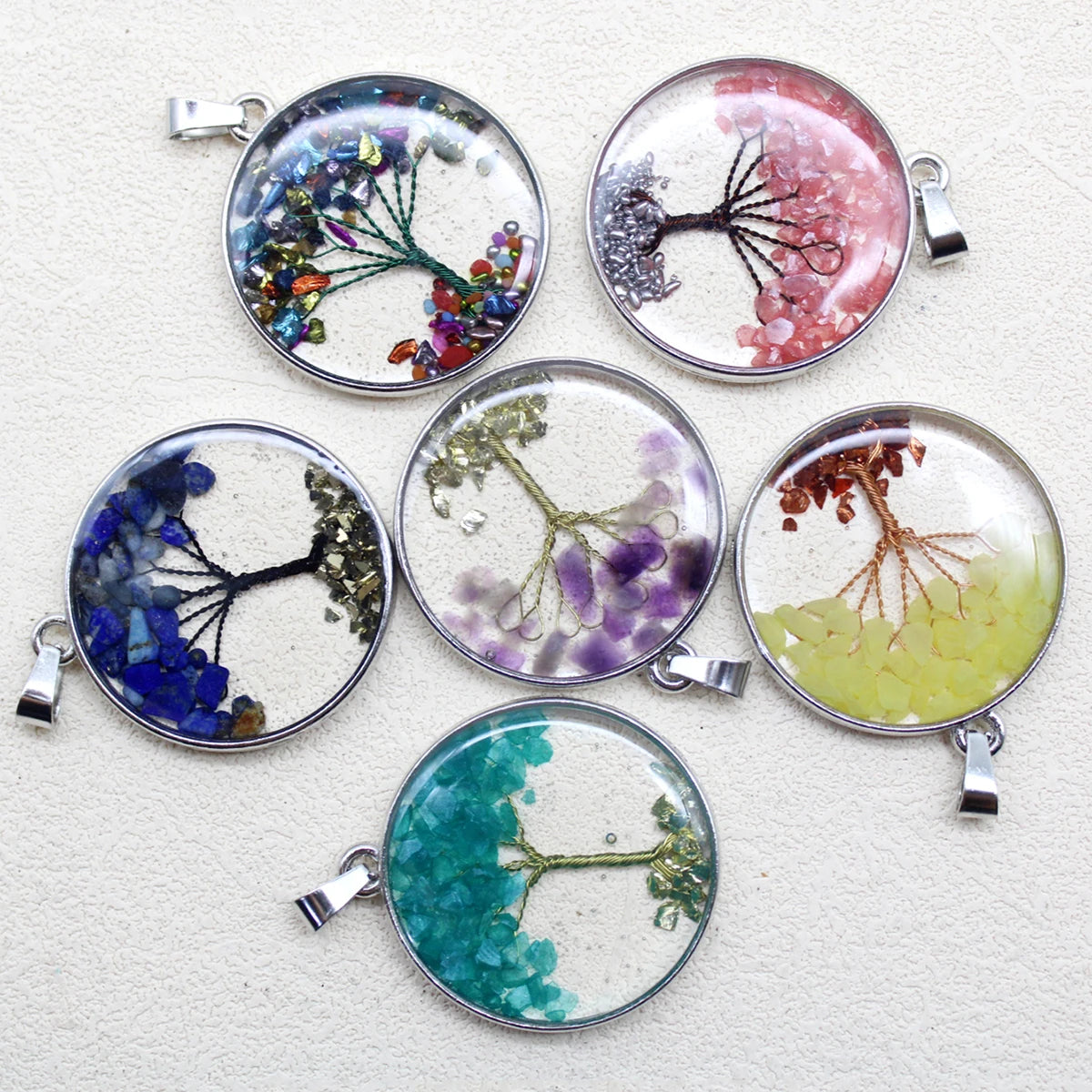 Set of round pendants with floral designs on a white background