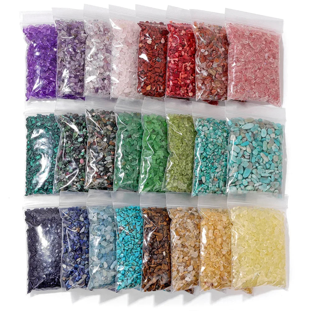 Assorted colored stones in clear plastic bags on a white background