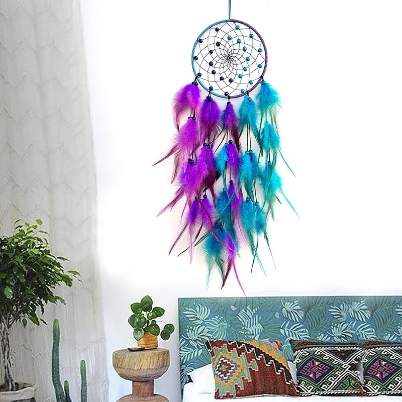 Colorful dreamcatcher hanging above a couch with decorative pillows in a room setting.