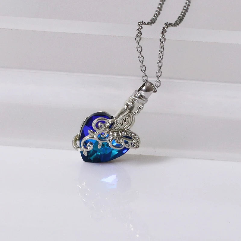 Heart-shaped blue pendant with silver chain on a white background