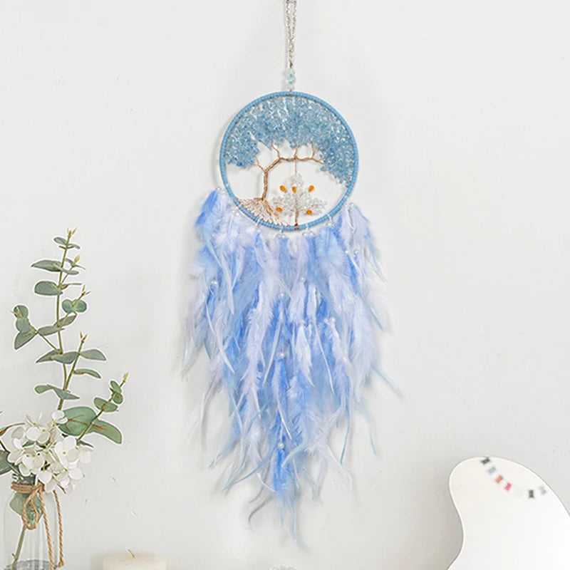 Blue and white dreamcatcher with feathers on a white background