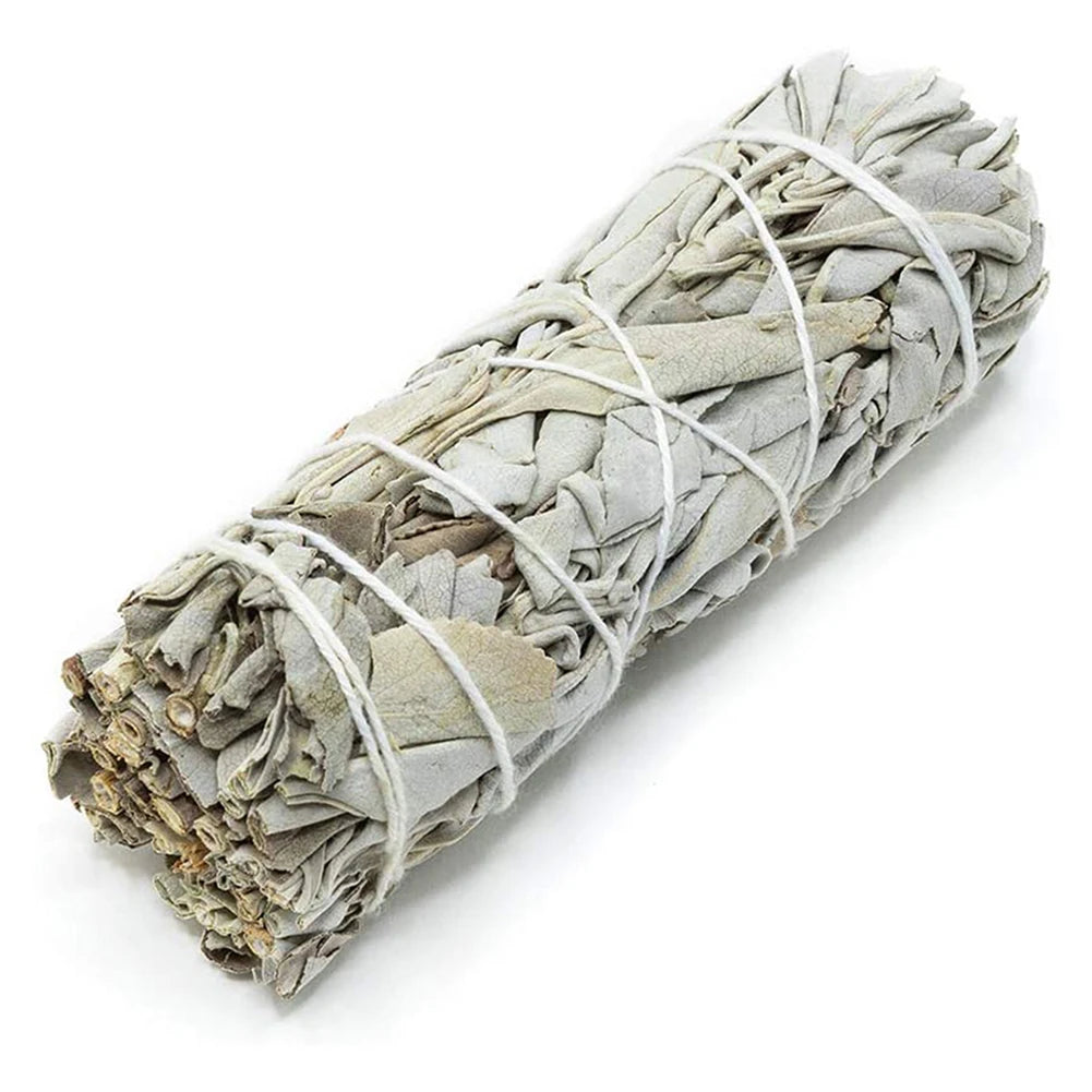 Rolled sage smudge stick tied with white string on a white background