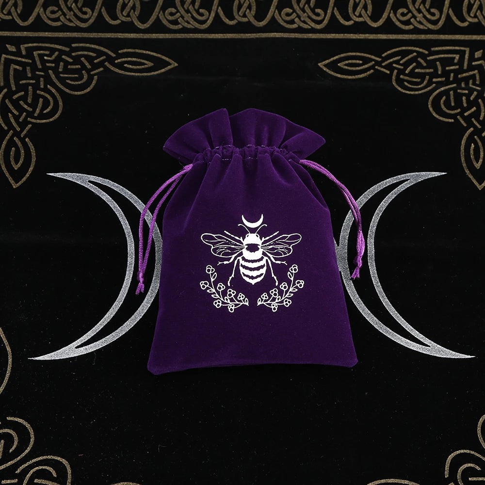 Purple drawstring bag with a white bee design on a black background with moon symbols.