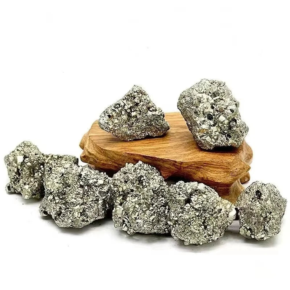 Decorative metallic rocks on a wooden stand with a white background