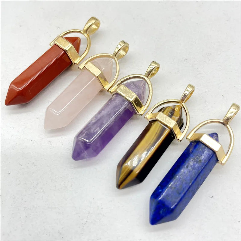 Five crystal pendants with gold accents on a white background