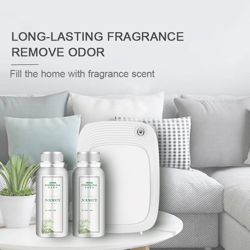 Fragrance diffuser and bottles on a table with a couch in the background