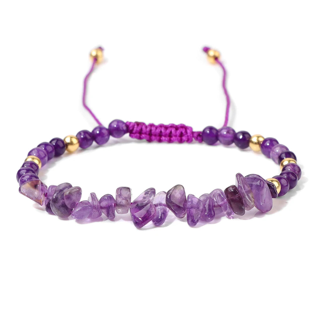 Purple beaded bracelet with gold accents on a white background