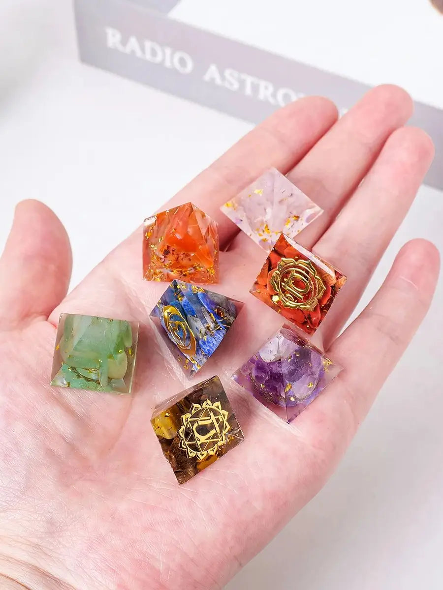 Hand holding colorful crystal stones with 'Radio Astro' in the background