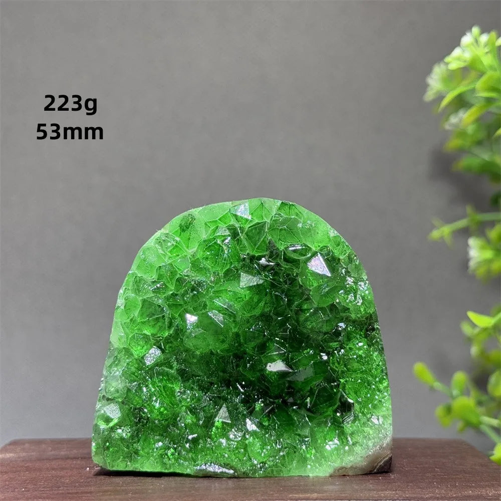 Green crystal rock on a wooden surface with a gray background