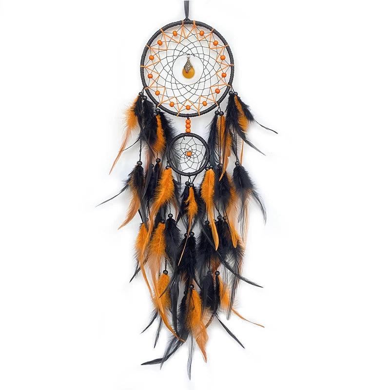 Black and orange dreamcatcher with feathers on a white background