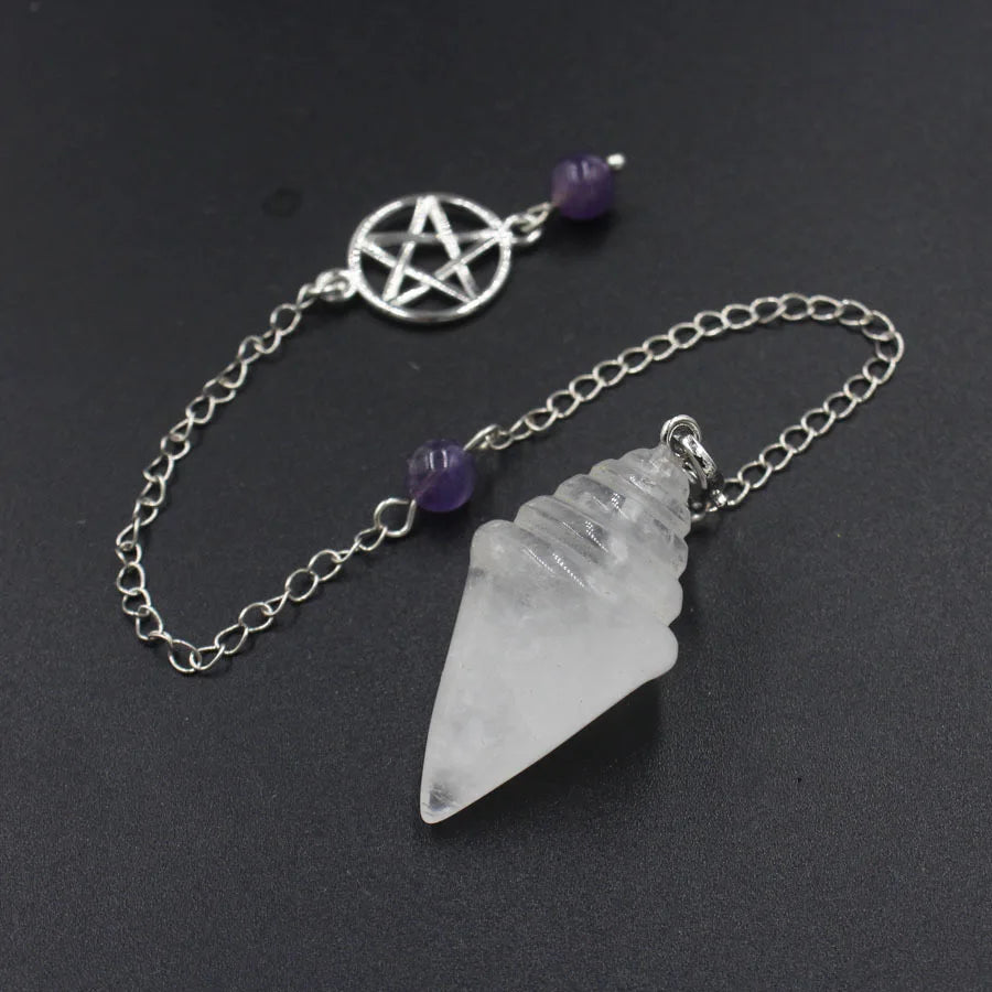 Crystal pendant with chain and pentacle charm on a dark background