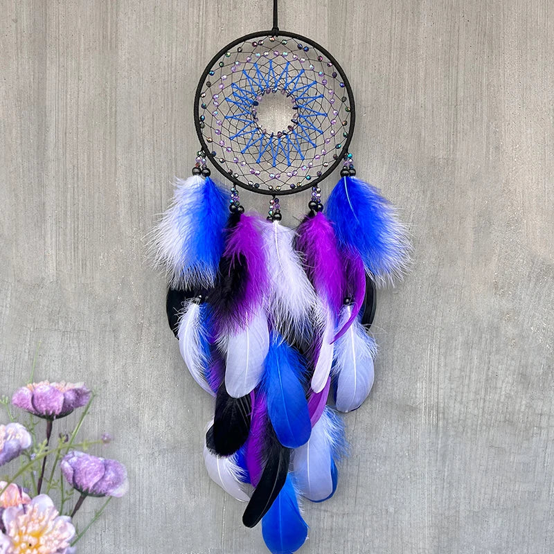 Dreamcatcher with blue, purple, and white feathers on a textured wall background
