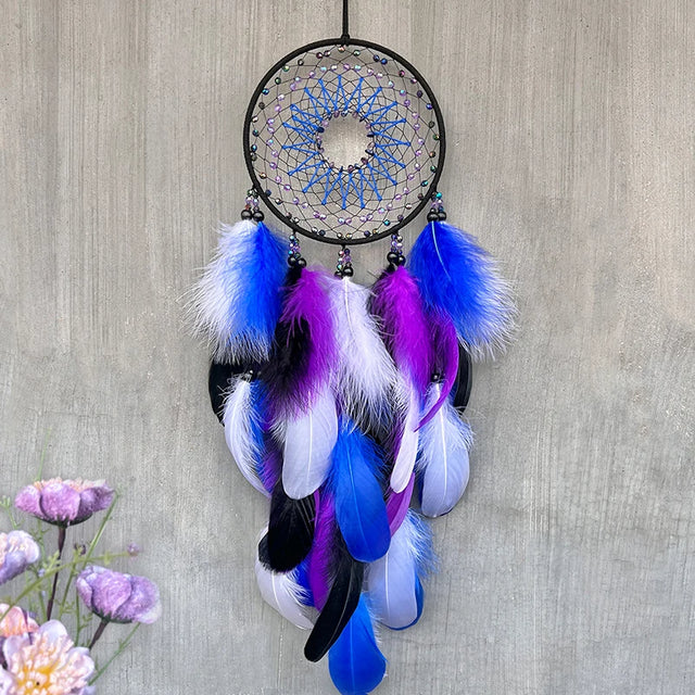 Dreamcatcher with blue, purple, and white feathers on a textured wall background
