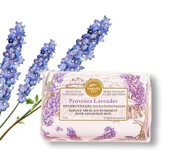Bar of soap with lavender packaging and lavender flowers on a white background