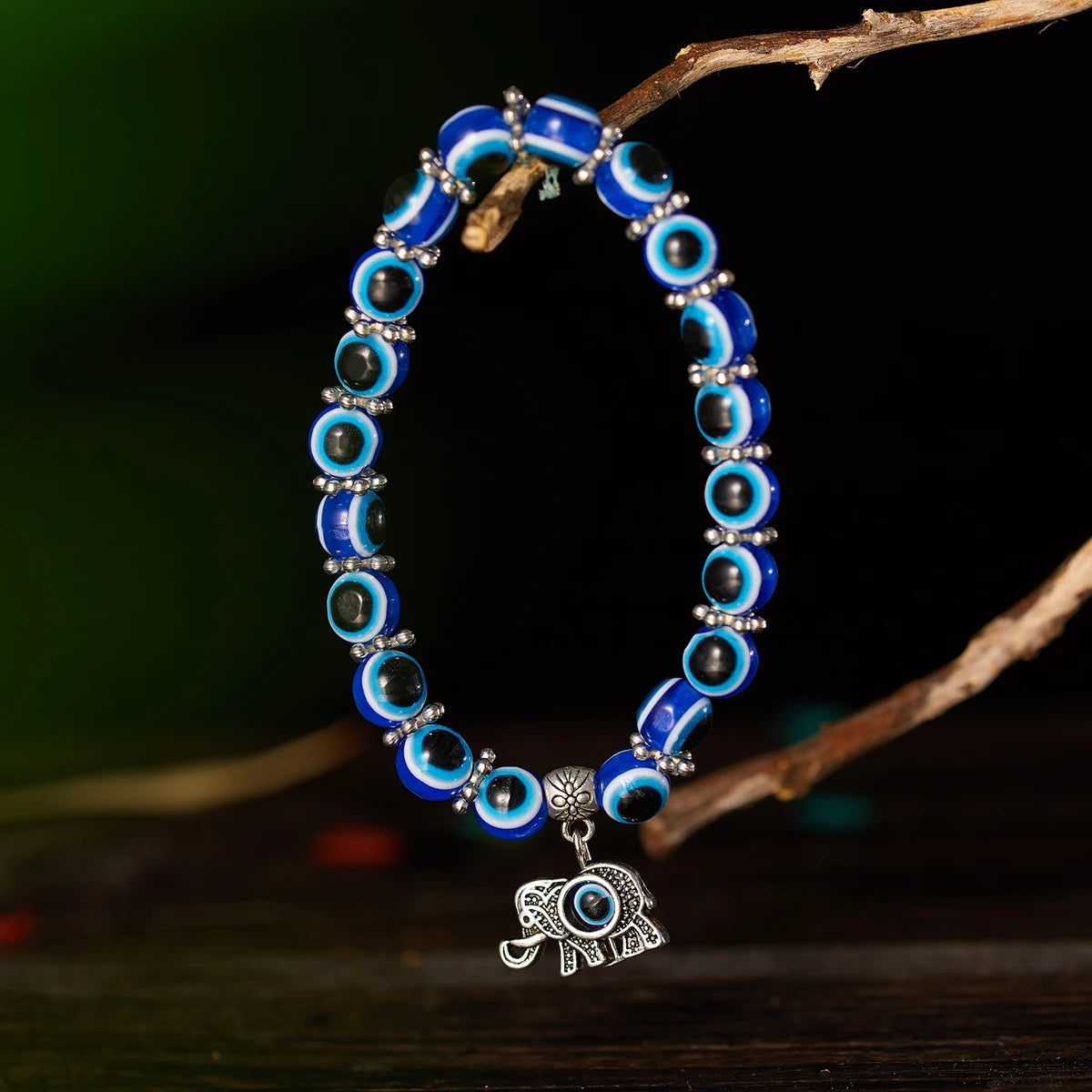 Blue beaded bracelet with an elephant charm on a dark background