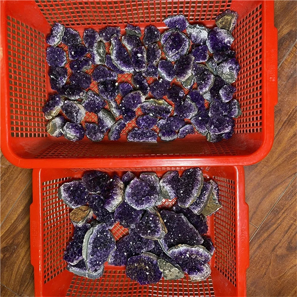 Red basket filled with purple and green crystal-like rocks on a wooden floor.
