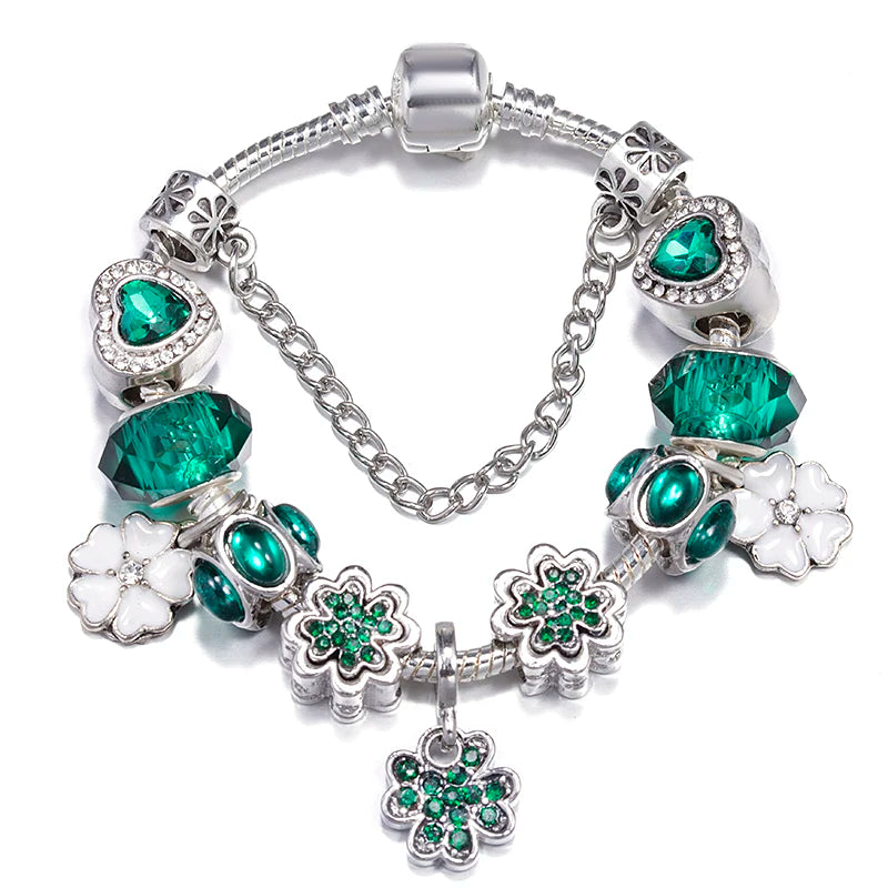 Bracelet with green and white charms on a white background