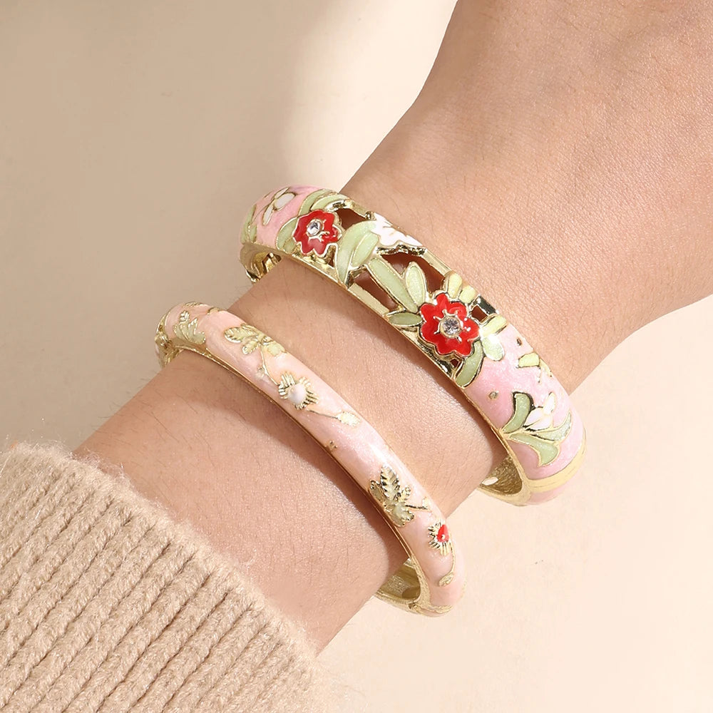 Two floral-patterned bracelets on a wrist against a beige background