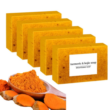 Yellow soap bars with turmeric powder and roots on a white background