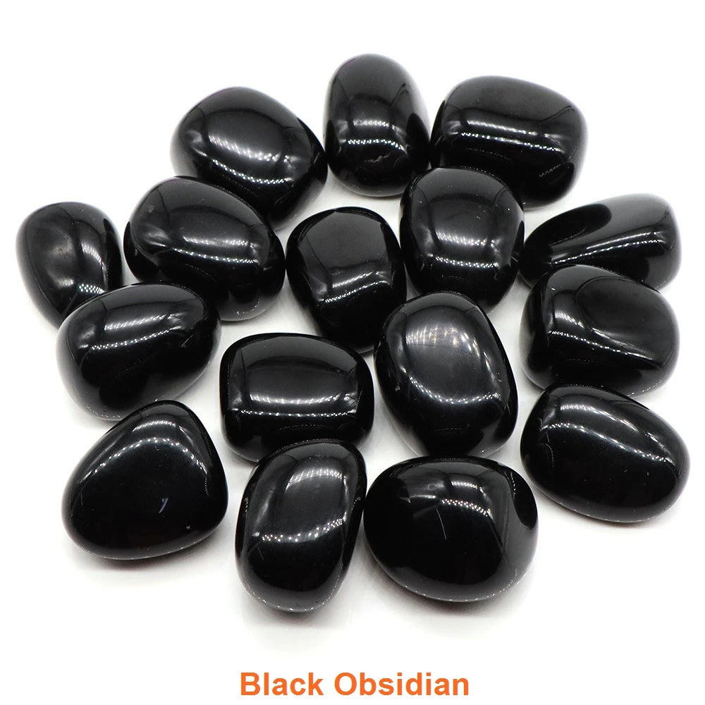 Collection of black obsidian stones on a white background