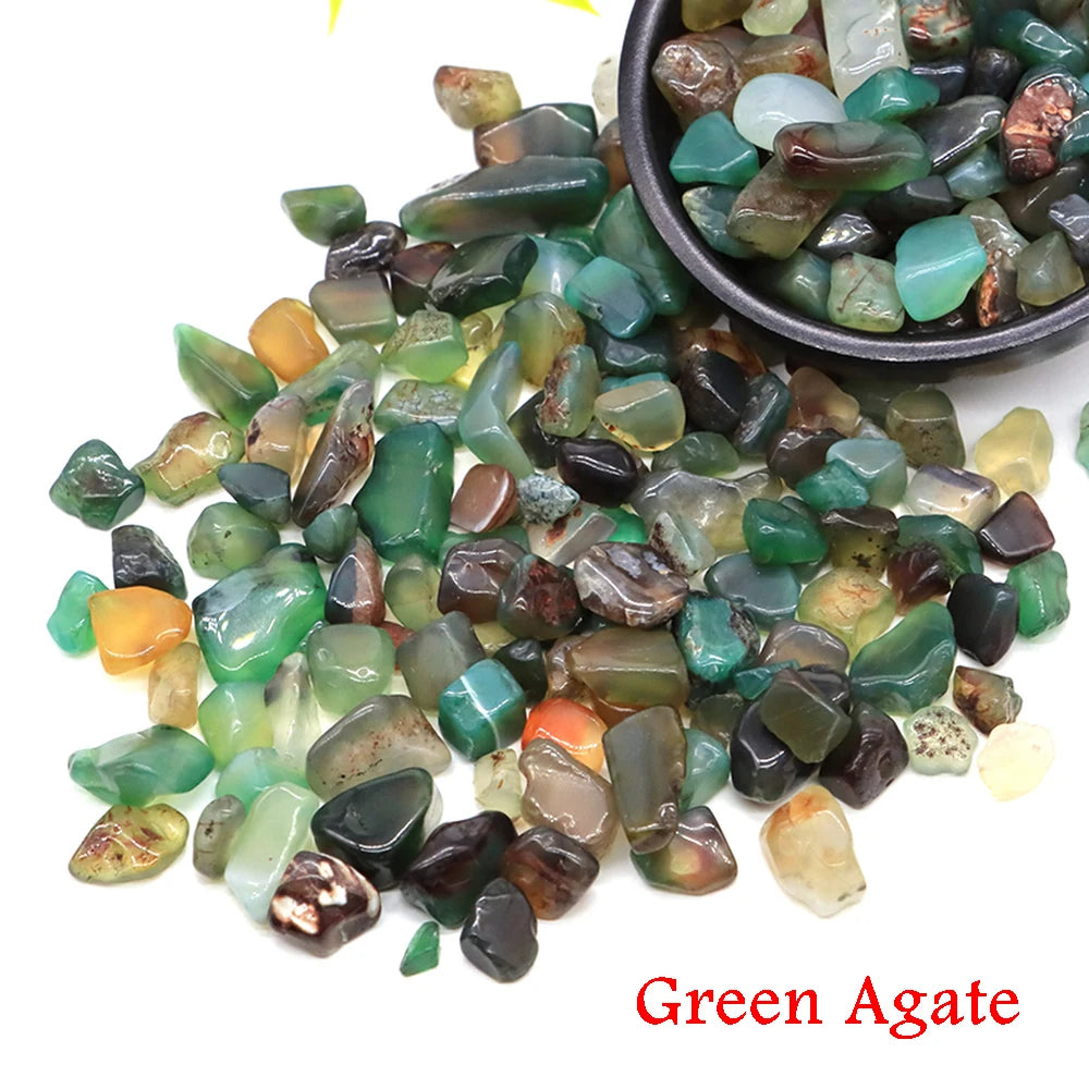 Pile of green agate stones with a bowl of stones in the background on a white background.