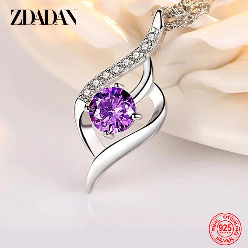 Silver pendant with a purple gemstone on a soft background, featuring the brand 'ZDADAN'.