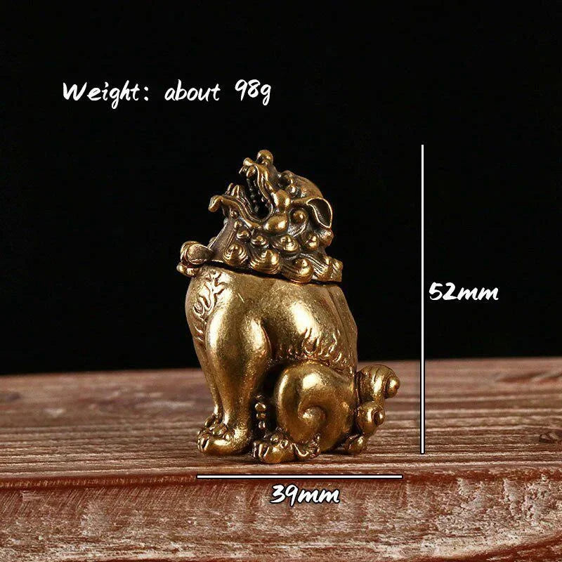 Gold lion statue with measurements on a wooden surface