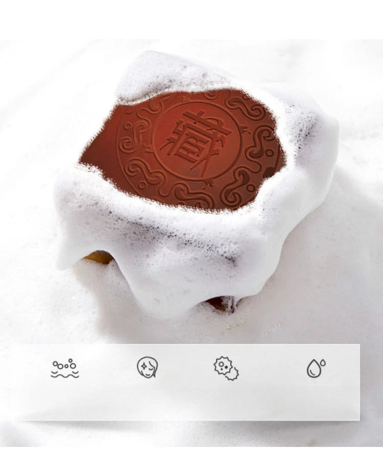 Chocolate bar with a brand logo partially covered in white powder on a light background