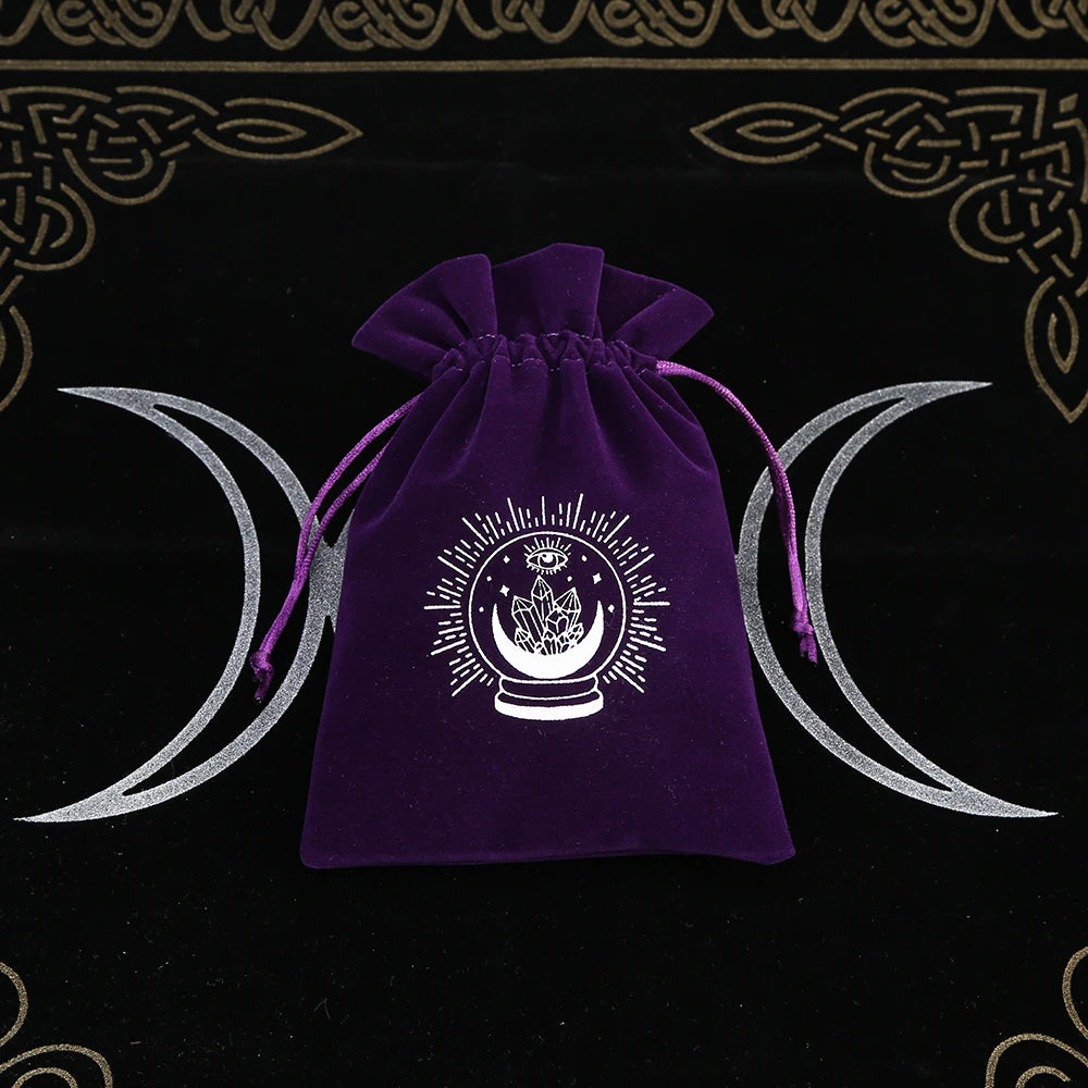 Purple drawstring bag with a white symbol on a black background with silver crescent moons.