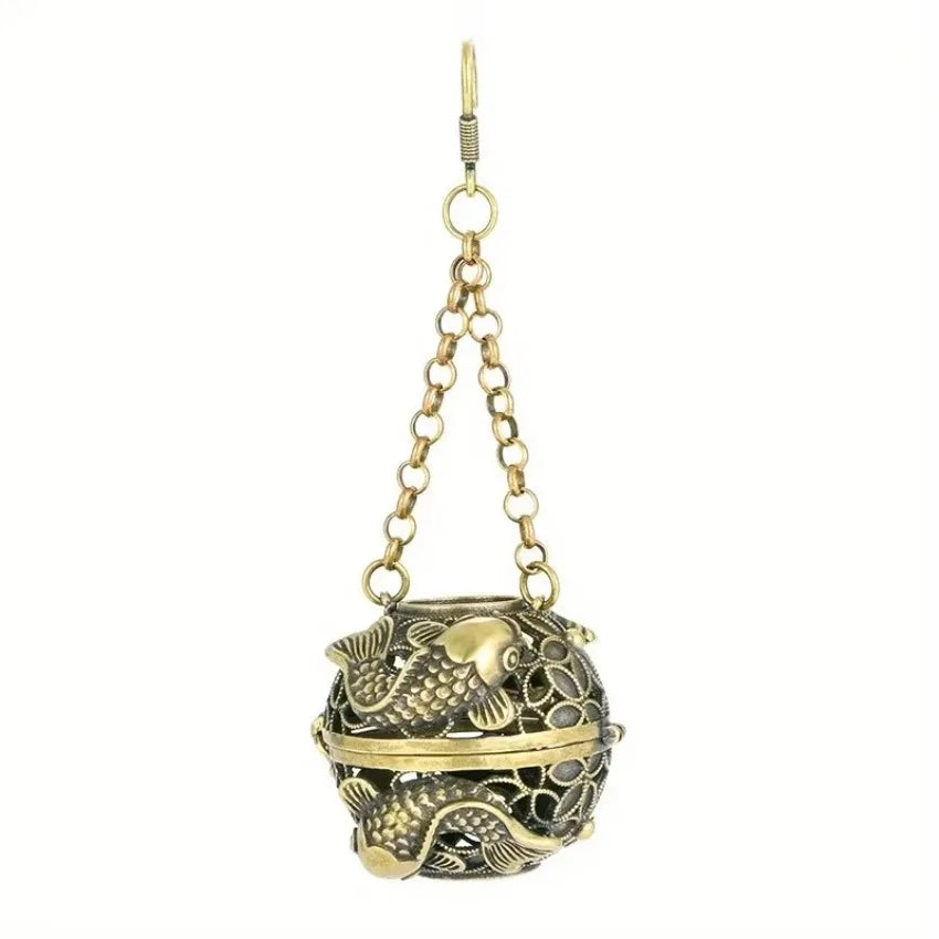 Decorative hanging ball with fish design on a white background