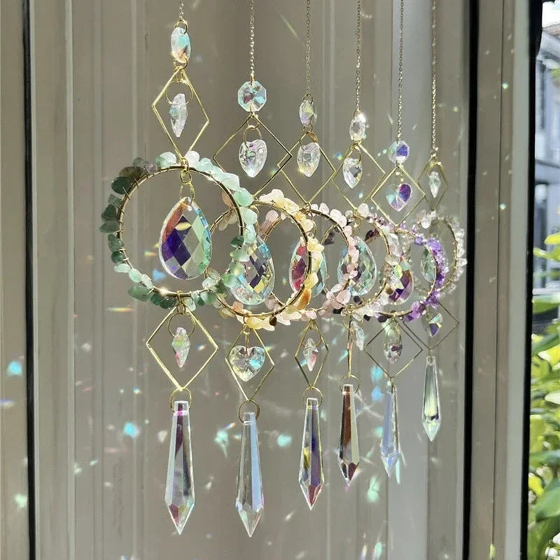 Decorative crystal hanging ornament with colorful gemstones in front of a window.
