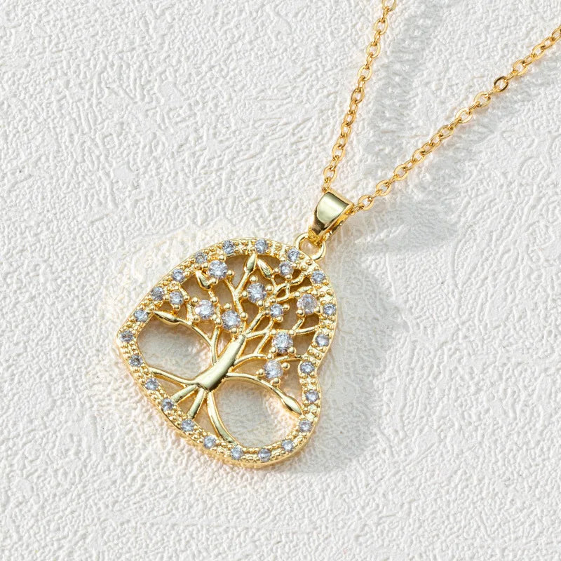 Gold tree-shaped pendant necklace on a light gray background