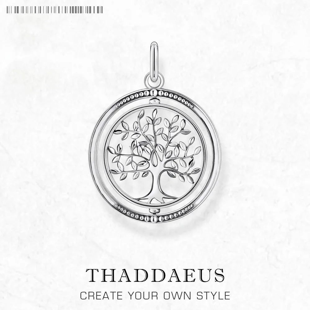 Silver tree of life pendant on a white background with 'Thaddaeus' branding.