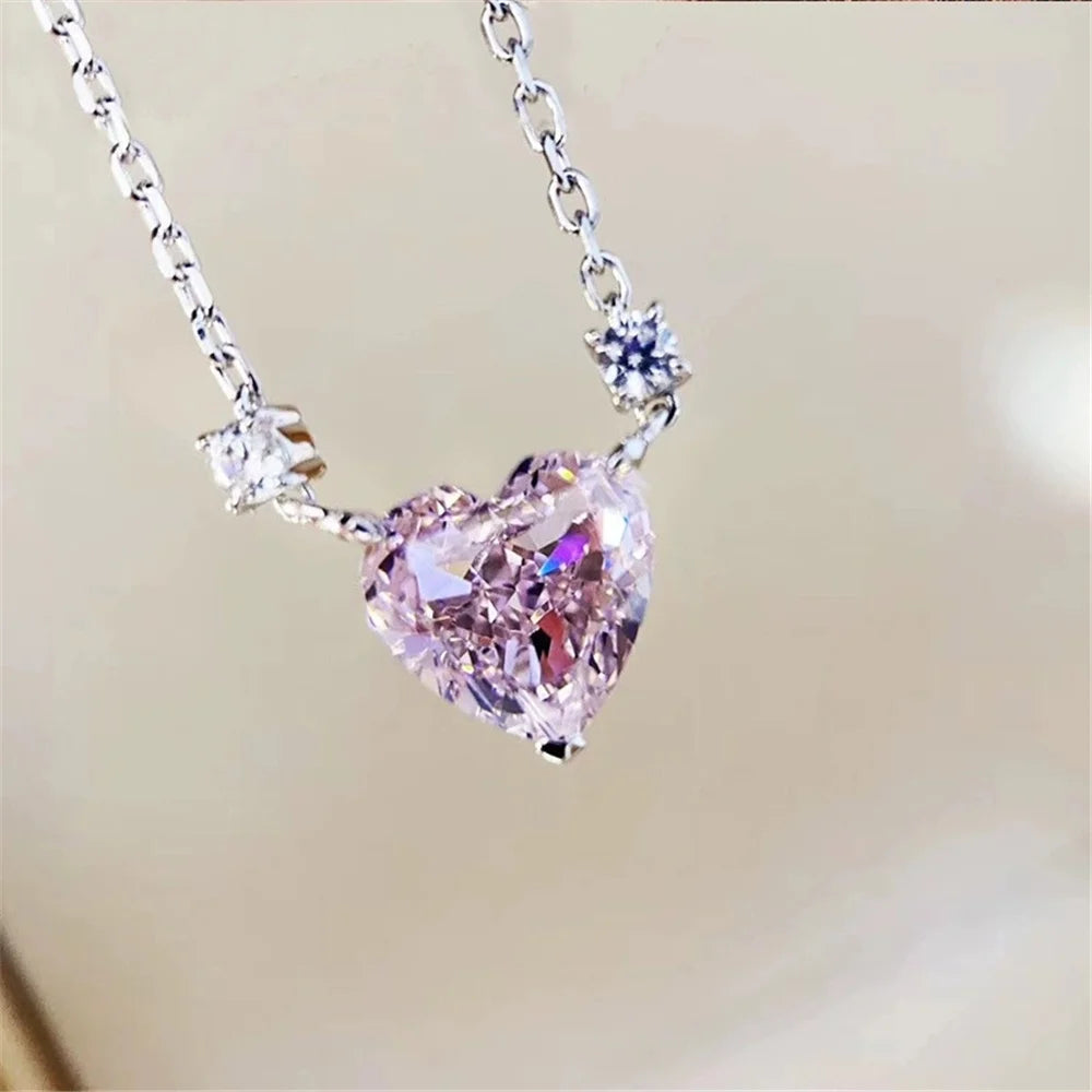Heart-shaped pink gemstone necklace on a blurred background