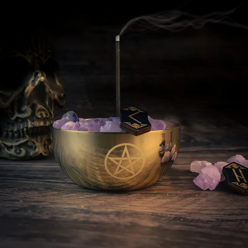 Incense burner with pentagram symbol on a dark background