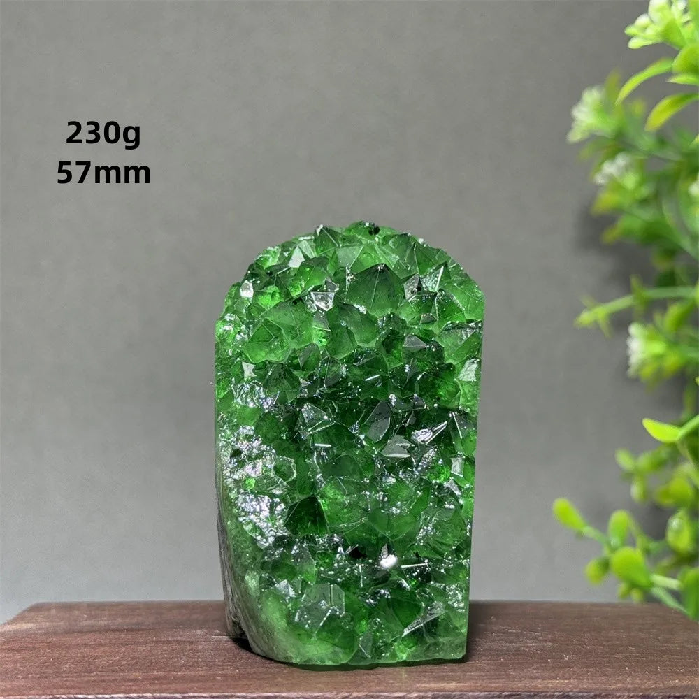 Green crystal rock on a wooden surface with a gray background