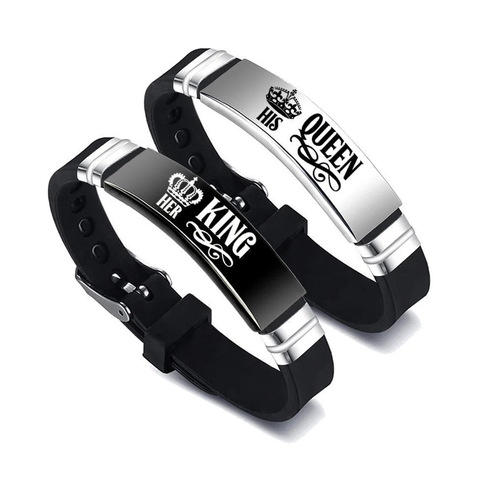 Pair of black and silver 'King' and 'Queen' bracelets on a white background