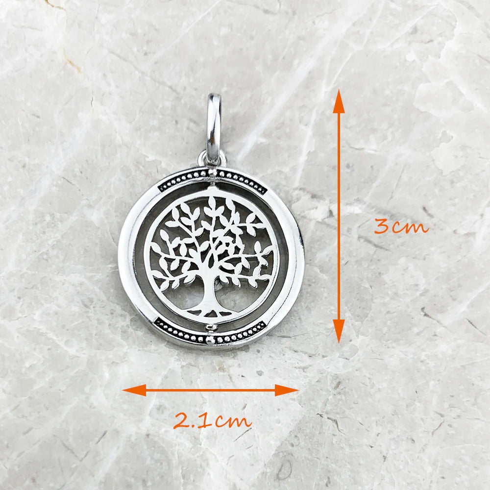 Silver tree of life pendant with measurements on a textured white background