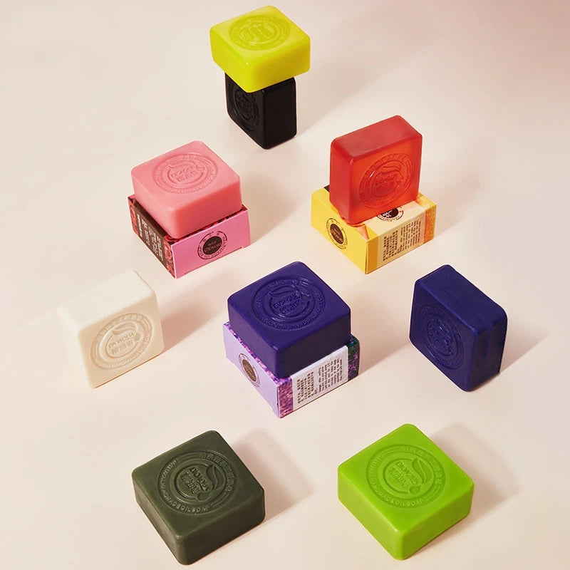 Assorted colorful soap bars on a light background