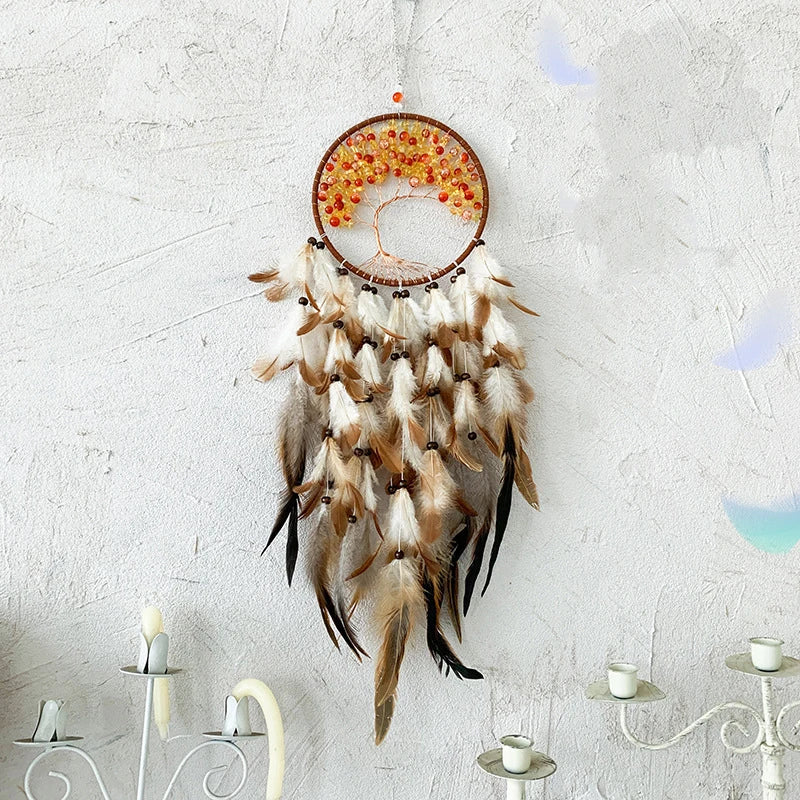Dreamcatcher with feathers on a textured wall