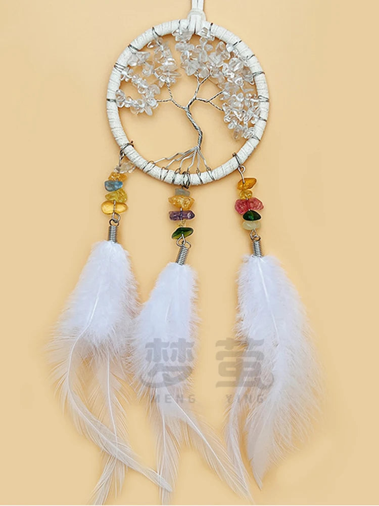 Dreamcatcher with feathers and colorful stones on a beige background