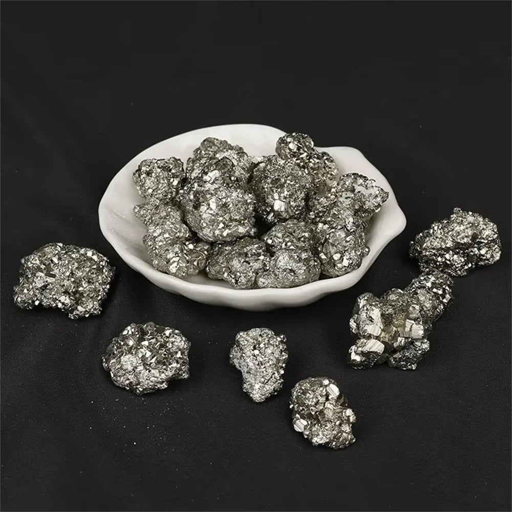 Pyrite crystals in a white dish on a black background