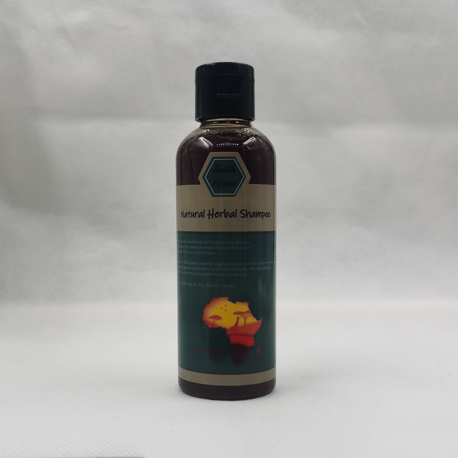 Bottle of natural herbal shampoo on a gray background