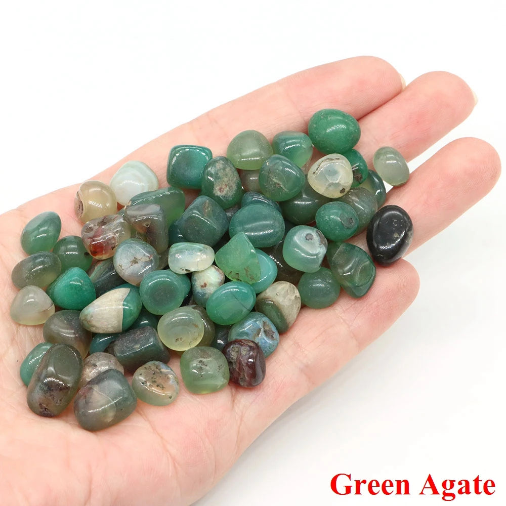 Hand holding green agate stones with a white background