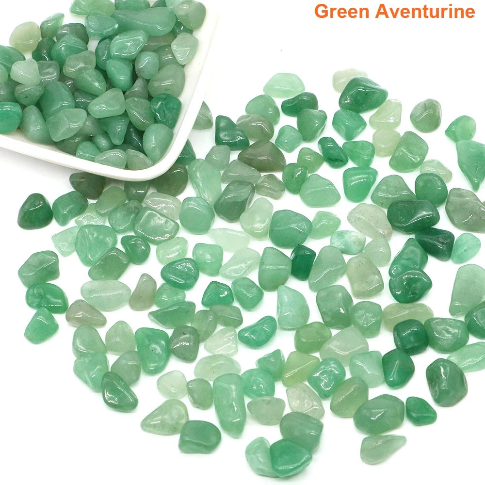 Green aventurine stones with a white scoop on a white background