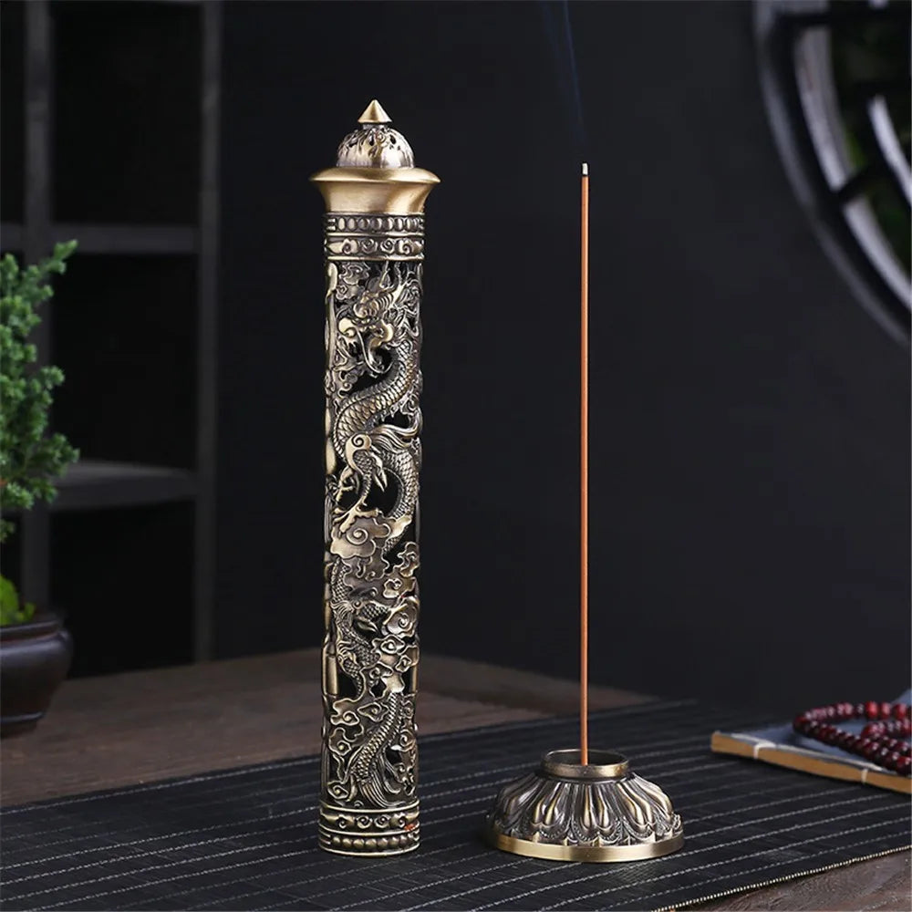 Decorative incense burner with intricate designs on a dark surface.